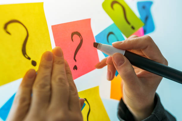 istock Businesswoman writing question marks on colorful sticky note paper 1150582798