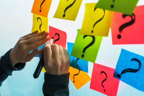 istock Businesswoman writing question marks on colorful sticky note paper 1150583391