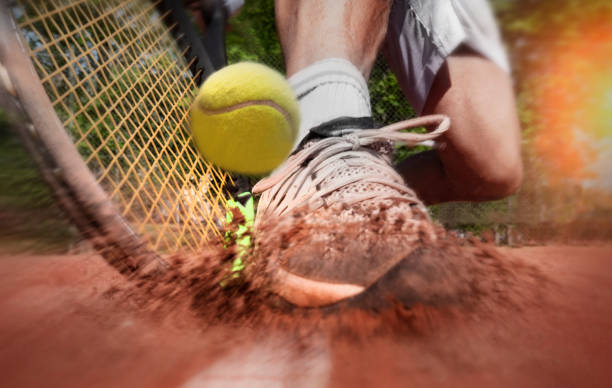 Tennis player on clay tennis court stock photo