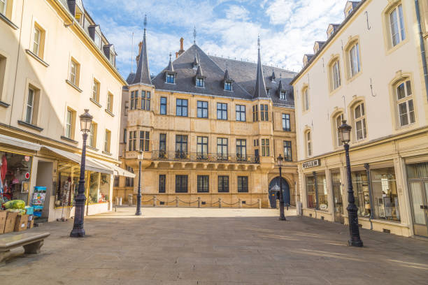 Peaceful scene of a narrow path lined with stone walls and colorful buildings in Luxembourg's historic old town.