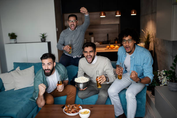 istock Friends watching sport on tv. 1150586849