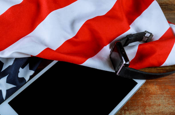 istock U.S national flag and e-tablet on wooden boards 1150588838