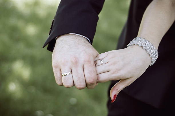 istock Bride's and groom's hands with wedding rings. 1150590003
