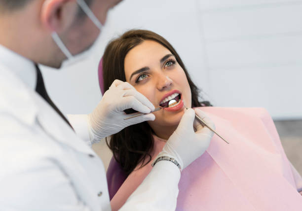 istock Young woman having teeth examined at dentists 1150590348