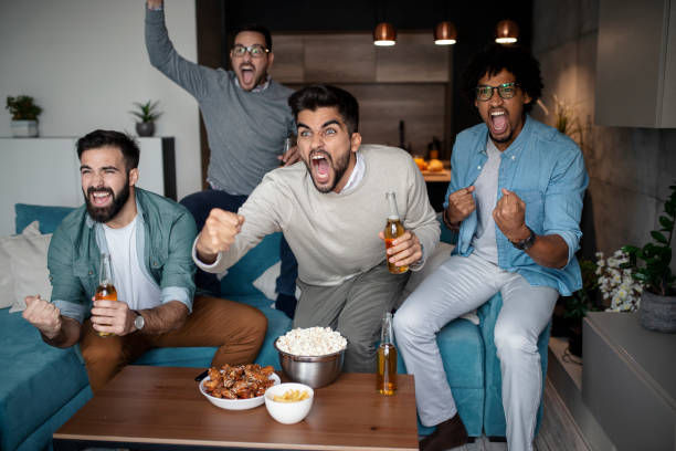 istock Friends watching sport on tv. 1150590645