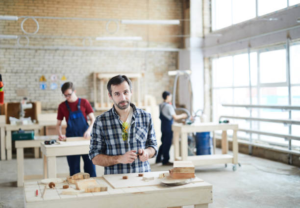 istock Handsome carpenter working at factory 1150591694