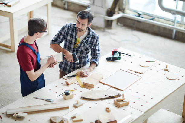 istock Showing how to make hole in wooden piece 1150591778