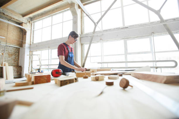 istock Busy guy in carpentry workshop full of light 1150591814