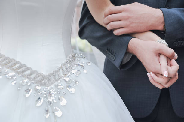 istock Detail bride groom holding hands 1150593277