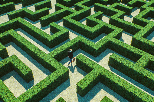 Businessman walking in maze. This is entirely 3D generated image.