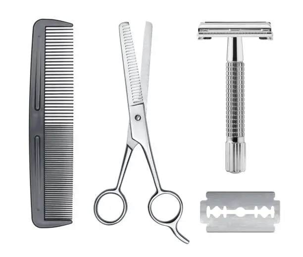 Photo of Comb, razor and scissors isolated on white background