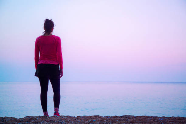 istock Woman enjoying pink sky 1150594557