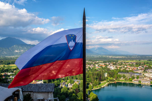 Slovenian Flag in Bled Slovenian flag flying high over Lake Bled in Slovenia julian alps stock pictures, royalty-free photos & images