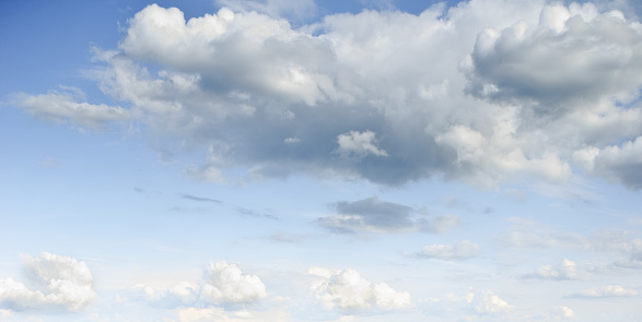 Cumulus clouds appear in a blue sky over Puget Sound at the Nisqually National Wildlife Refuge near Olympia, Washington State, USA.