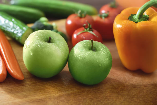 Fresh fruits and vegetables on the old wooden board