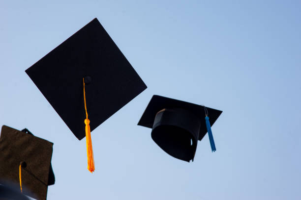 istock Throw a black hat of graduates in the sky. 1150604856