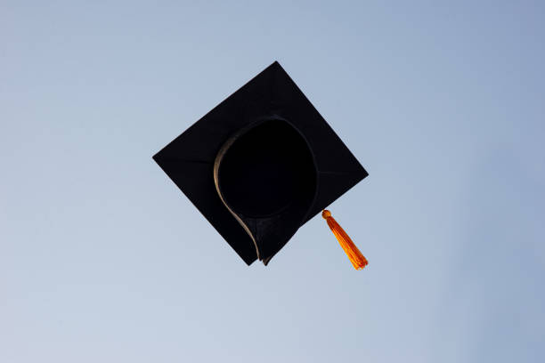 istock Throw a black hat of graduates in the sky. 1150604891