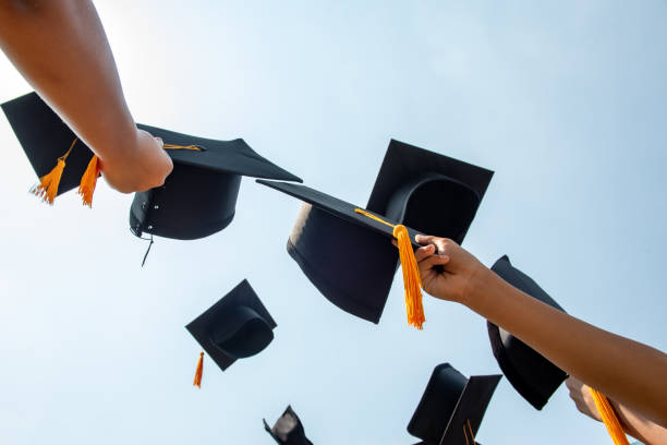 istock Throw a black hat of graduates in the sky. 1150604896