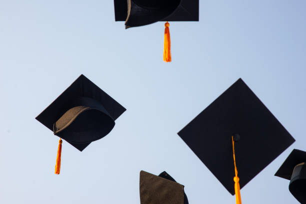 istock Throw a black hat of graduates in the sky. 1150604919