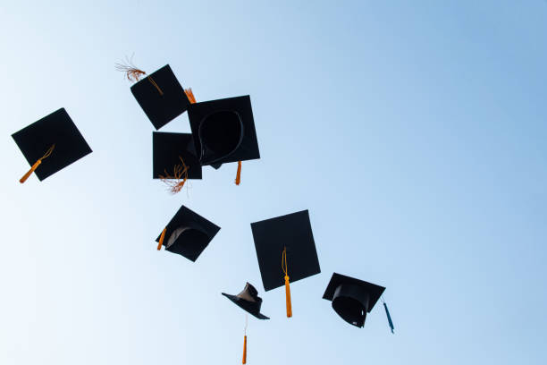 istock Throw a black hat of graduates in the sky. 1150604928
