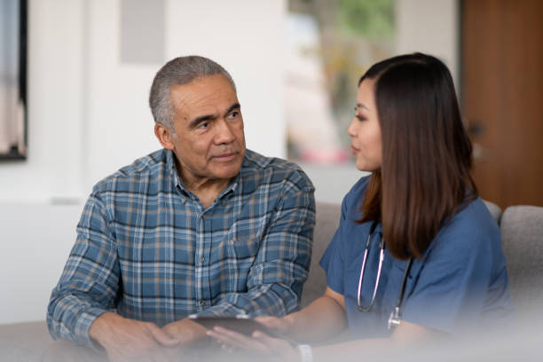 istock Young doctor with elderly patient 1150608037