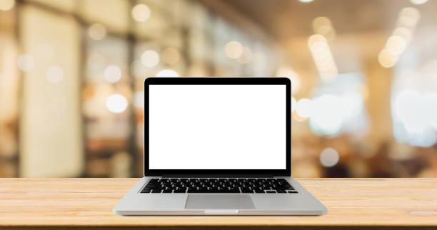 istock Blank screen laptop computer on wood table top with blur cafe restaurant with abstract bokeh light defocused background 1150608781