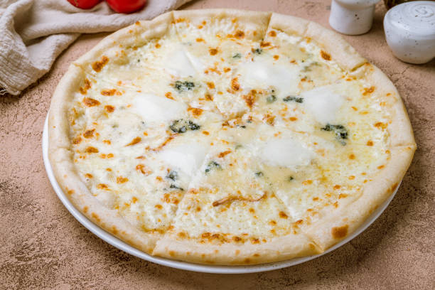 istock Pizza Quattro formaggi on white plate 1150609035