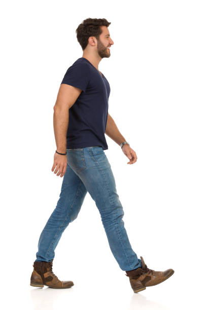 istock Walking Smiling Man In Blue T-shirt, Jeans And Boots 1150609375