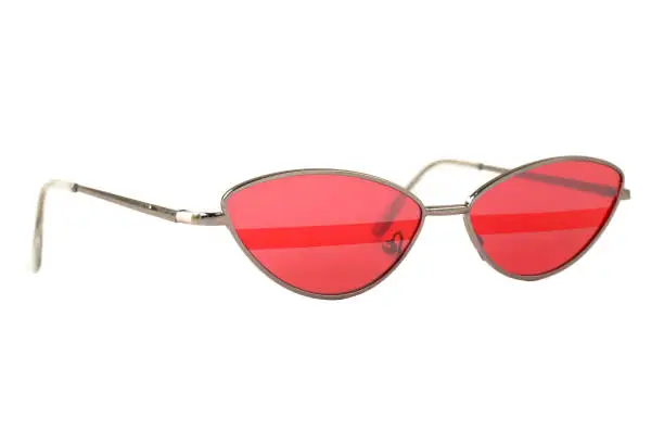 Red Sunglasses with stripe and silver thin frame isolated on white, side view.