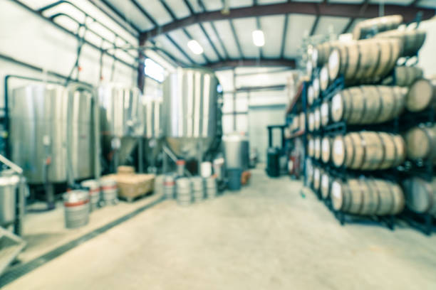 istock Filtered image blurry background stack of barrels in cellar at American brewery 1150613779