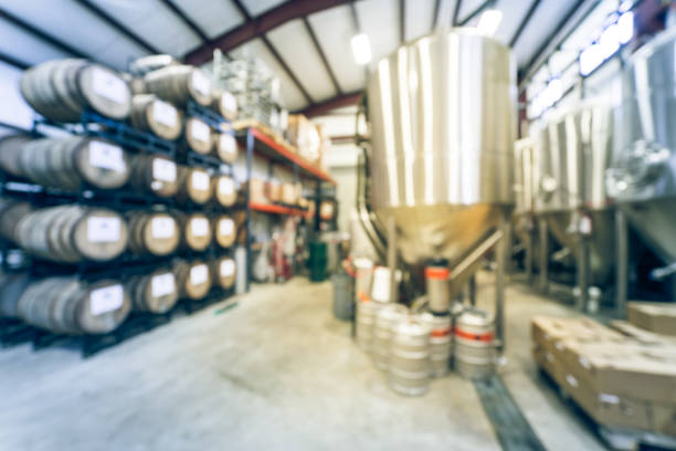 istock Filtered image blurry background stack of barrels in cellar at American brewery 1150613787