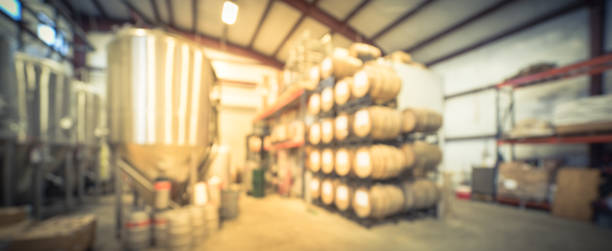 istock Panoramic view blurry background stack of barrels in cellar at American brewery 1150613803