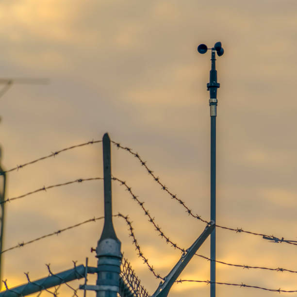 istock Square Chain link fence with barbed wire securing a Power Plant in Utah Valley 1150618555