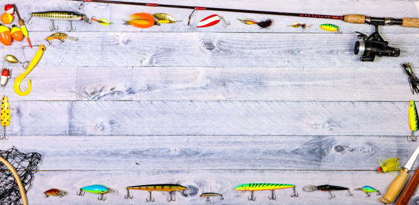 istock Fishing tackle overhead on wooden background with copy space 1150623038