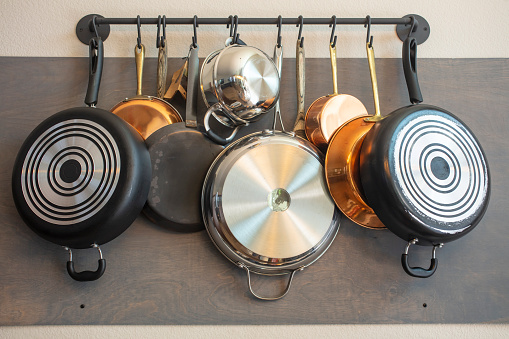 Kitchen wall rack for hanging pots, pans, aprons, and other utensils for efficient organization, storage and decor