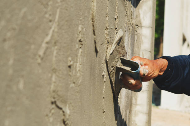 istock hand of worker plastering cement on wall 1150625841