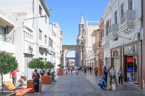 People walking at the Calle Mercaderes shopping street near Plaza de Armas in Arequipa, Peru, during an early morning.