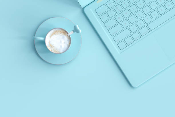 Minimal idea concept. coffee blue cup beside laptop