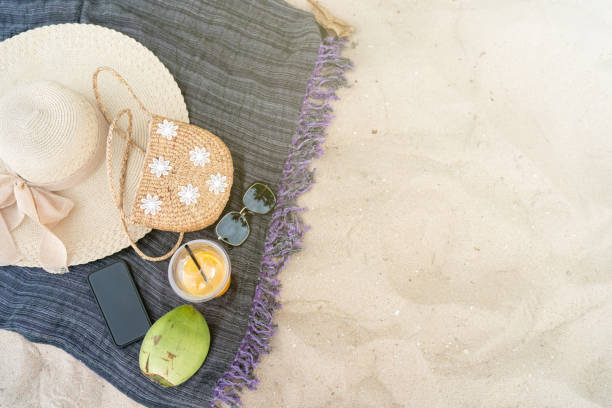 istock Summer beach bag sea hat and sunglasses on sandy beach 1150632674
