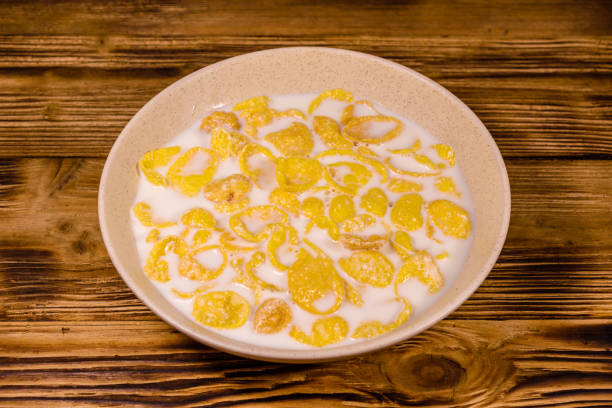 istock Ceramic plate with cornflakes and milk on a wooden table. Healthy eating 1150632767
