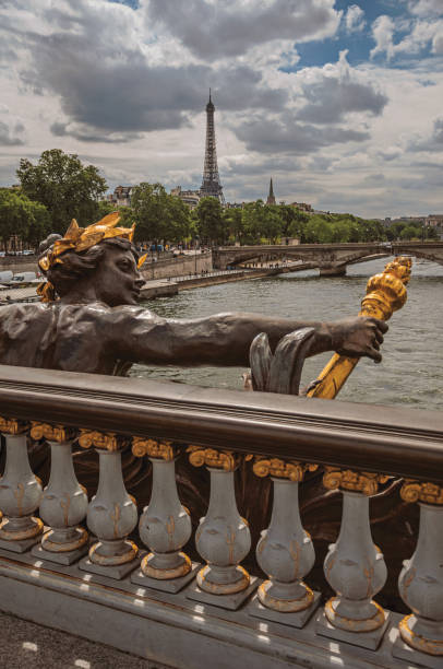 istock Golden statue on bridge at Seine River and Eiffel Tower in Paris 1150632798