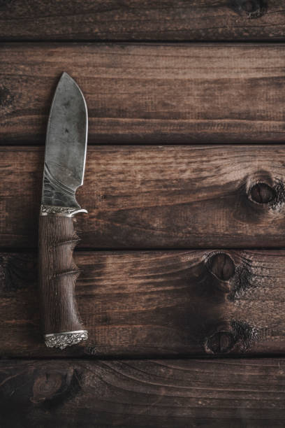 istock knife on wooden background 1150637615