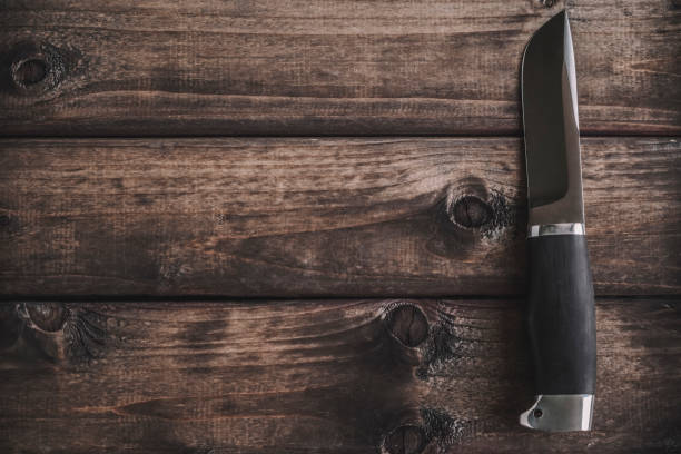 istock knife on wooden background 1150637617