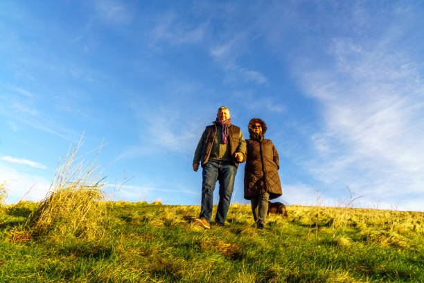 istock Senior couple walking on countryside path in winter 1150641318