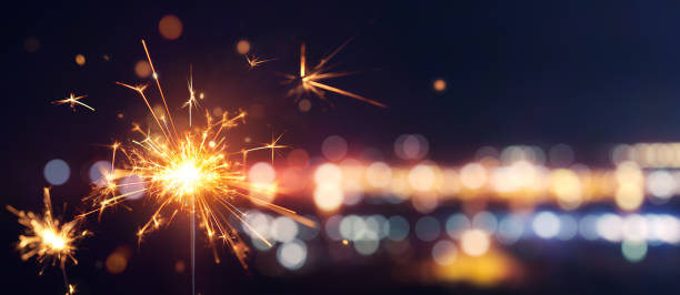 istock Glittering burning sparkler against blurred bokeh light background 1150644371