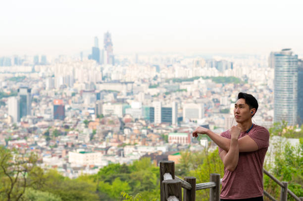 istock Sporty man stretching arm in city 1150644737