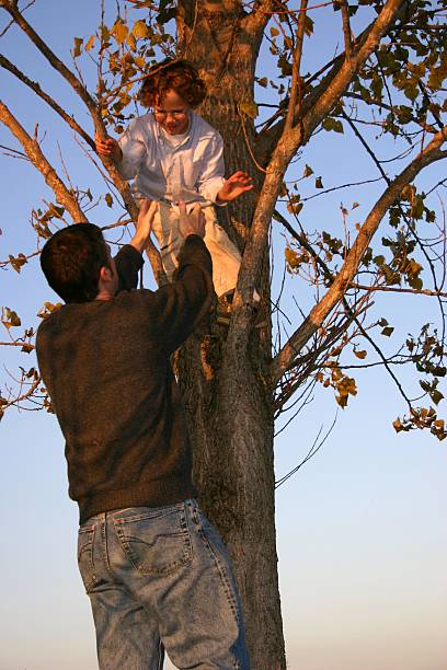 istock little boy getting out of tree by Dad 115064851