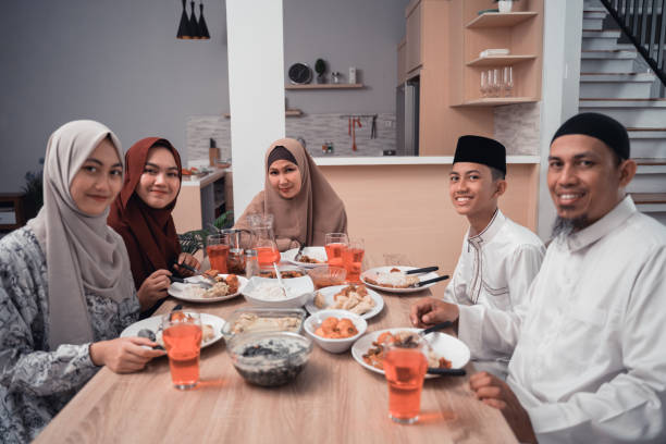 istock happy muslim having dinner at home break fasting on ramadan 1150652147