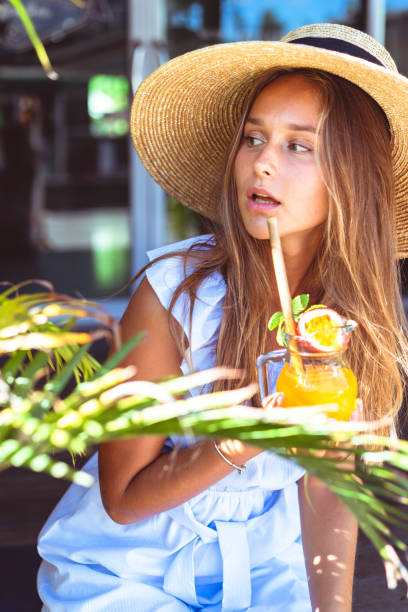 istock Young woman holding a cocktail 1150652701