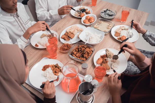istock close up of hand eating in dinner table together 1150652920